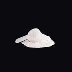 Close-up of pink pre-workout powder texture with scoop - AMBROSIA Nitric Shock Fruit Punch.